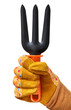 Human hand in a yellow protective glove holding gardening tool