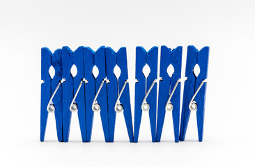 blue colorful wooden clothespins on a white background