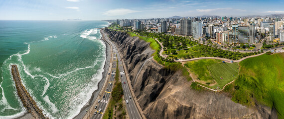 LIMA, PERU: Aerial view of Miraflores town, cliff and the Costa Verde high way