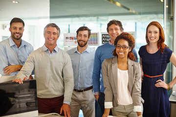 Sticker - Meet the team. Portrait of a diverse team of professionals working in an office.