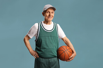 Sticker - Smiling elderly man holding a basketball