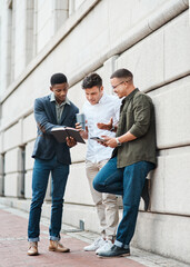 Aufkleber - These streets were made for success. Shot of a group young businessmen using a digital tablet together against an urban background.