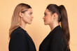 © Andrii - Two business woman facing each other face to face eyes to eyes friends business competition with partner concept