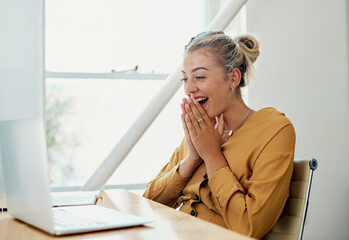 Poster - This is the best news ever. Cropped shot of an attractive young businesswoman sitting and alone celebrating while using her laptop in the office.