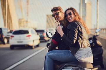 Poster - The city is too big to leave unexplored. Rearview shot of a young attractive couple riding a scooter around town.