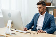 © SHOTPRIME STUDIO - a man in a suit wearing glasses works at a computer office executive