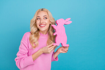 Poster - Photo of funky millennial curly blond lady hold bunny wear pink jumper isolated on blue color background