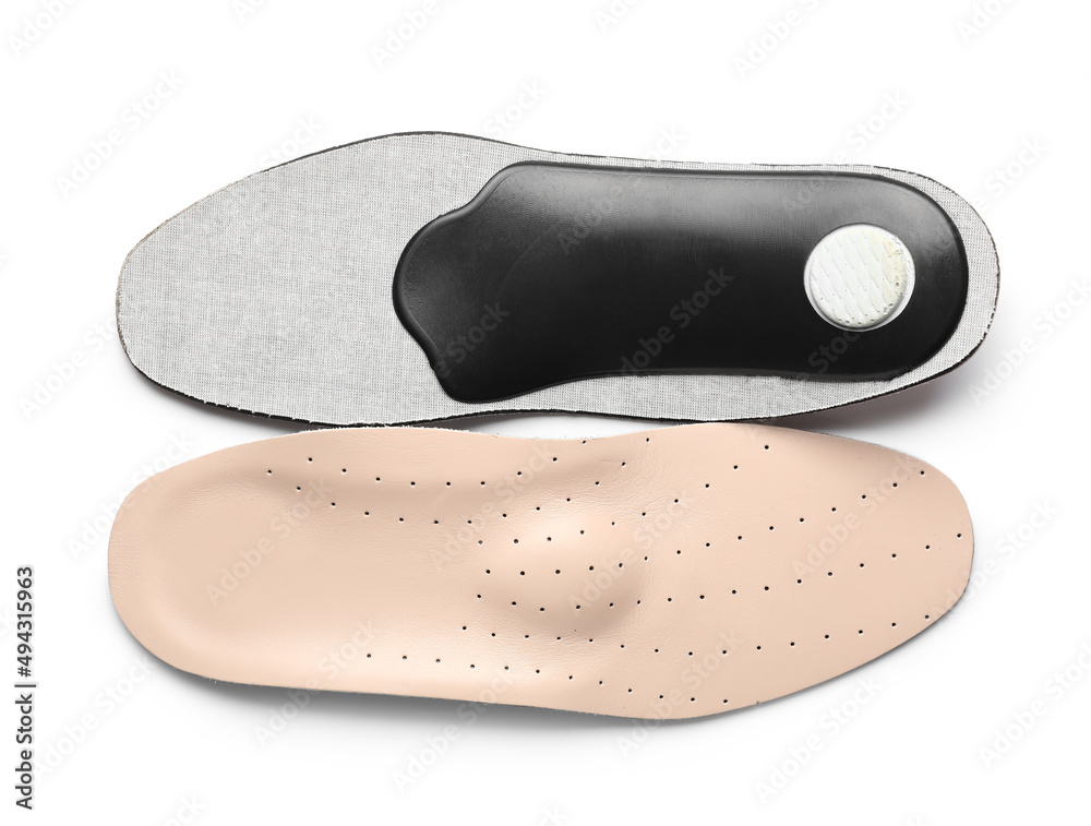 Beige orthopedic insoles on white background