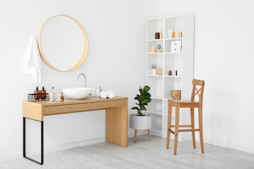 Poster - Stylish interior of bathroom with different supplies and modern sink near white wall