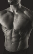 © A Stock Studio - Male torso. Close-up of chest and abs muscles. Black and white photo. Banner poster.