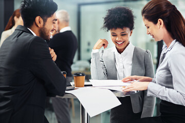 Aufkleber - Everybody is on the same page. Shot of a group of businesspeople talking together while sitting at a table in an office.