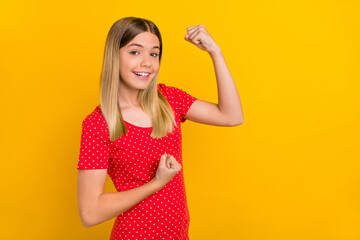 Poster - Portrait of cheerful overjoyed person raise fists yeah attainment look camera isolated on yellow color background