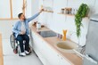 © Serhii - Disabled Young Man in Wheelchair Preparing Food In Kitchen