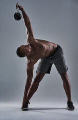 Poster - Theres nothing quite like exercising with a kettle bell. Full length shot of an athletic young man working out with a kettle bell.