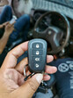 © Ekahardiwito - Hand hold new car alarm remote with blurry background.