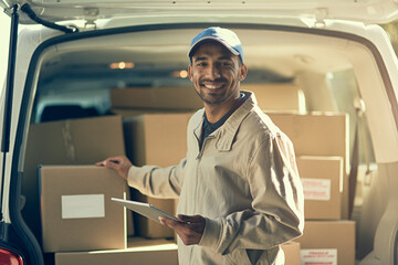 Aufkleber - Maintaining fast and efficient delivery. Portrait of a delivery man using a digital tablet while checking the boxes in his van.
