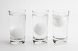 Eggs in water test on transparent glass , Egg freshness test on white background , Bad egg floats in water