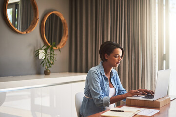 Poster - Managing pregnancy and her monthly bills. Shot of a pregnant young woman using a laptop while working from home.