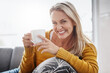 © Thurstan H/peopleimages.com - For a relaxing time at home just add coffee. Portrait of an attractive mature woman enjoying a beverage while relaxing on the sofa at home.