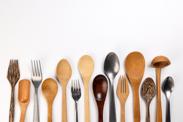 Varity of wooden metal plastic spoon kitchen tableware on white background copy text space