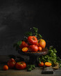 Still life with red and yellow tomatoes. Dark and moody photography