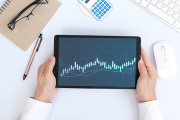 Poster - Hand using tablet and analysing banking and investment growth graph to develop smart financial decision for business plan strategy, and analysing forex trading grap