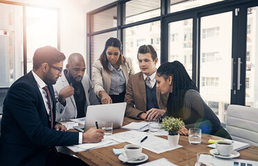 Aufkleber - Teamwork is the ultimate productivity booster. Shot of a group of young businesspeople using a laptop together during a meeting in a modern office.