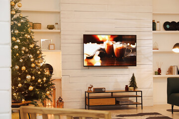 Sticker - Plasma TV on white wooden wall in living room beautifully decorated for Christmas