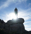 Person standing on a rock and a casting silhouette in the El Torcal de Antequera rock and boulder area in the Malaga region of Spain.
