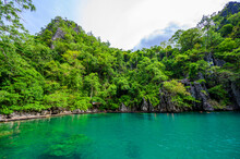 Kayangan Lake - Blue Crystal Water In Paradise Lagoon - Walkway On Wooden Pier In Tropical Scenery - Coron Island, Palawan, Philippines.