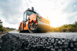 Vibratory asphalt rollers compactor compacting new asphalt pavement. Road service repairs the highway	
