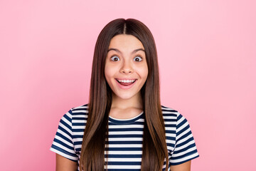 Poster - Photo of adorable shocked girl dressed striped clothes smiling open mouth big eyes isolated pink color background