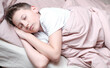 © lelechka - Boy teen sleeping on the bed in morning. Beds blanket is in light pink colors