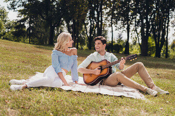 Sticker - Portrait of two attractive cheerful couple idyllic harmony sitting on plaid singing song romance on fresh air outdoors