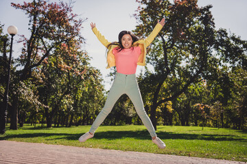 Full length body size view of attractive free cheerful girl jumping having fun freedom trip good morning outdoors