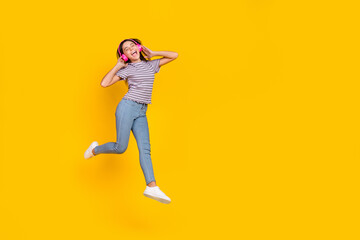 Poster - Full length photo of young girl excited enjoy music earphones melody walk isolated over yellow color background