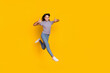 Full body photo of young girl jump show thumbs-up approve select ads good isolated over yellow color background
