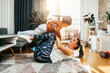 © Dusko - Beautiful young mother practicing fitness exercising and yoga together with her adorable little son. They are enjoying, playing and smiling in home living room.