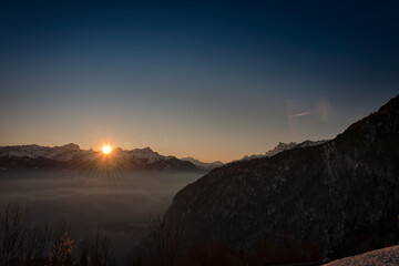 Wall Mural - Beautiful sunrise over an alpine mountain in Switzerland