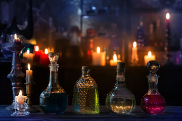 Wall Mural - magic potions in bottles on wooden background