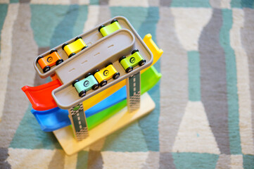 Poster - Close-up top shot of a car toy complex with different small colorful cars