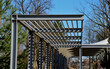 white canvas stretched, shading from the sun and rain over the terrace of the restaurant, on the playground in the kindergarten, on the platform of the promenade. pergola with metallic gray beams 