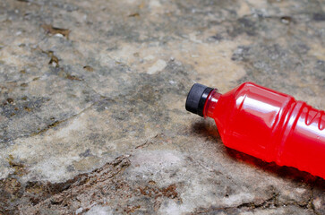 Poster - Closeup of a red Electric Energy Drink bottle isolated on a marble background with a copy space