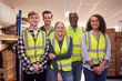 © Monkey Business - Portrait Of Multi-Cultural Team Wearing Hi-Vis Safety Clothing Working In Modern Warehouse