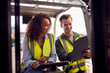 © Monkey Business - Male And Female Staff Operating Fork Lift Truck In Modern Warehouse