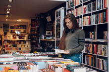 Woman Buying Books At A Bookstore