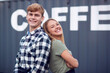 © Monkey Business - Portrait Of Male And Female Interns At Freight Haulage Business Standing By Shipping Container