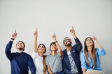 No matter how far it seems, go after your dream. Shot of a group of young people pointing towards something above them inside.