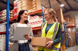 © Monkey Business - Female Team Leader With Clipboard In Warehouse Training Intern Standing By Shelves