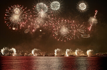 Poster - Beautiful view of fireworks in the sky with a lake in the foreground